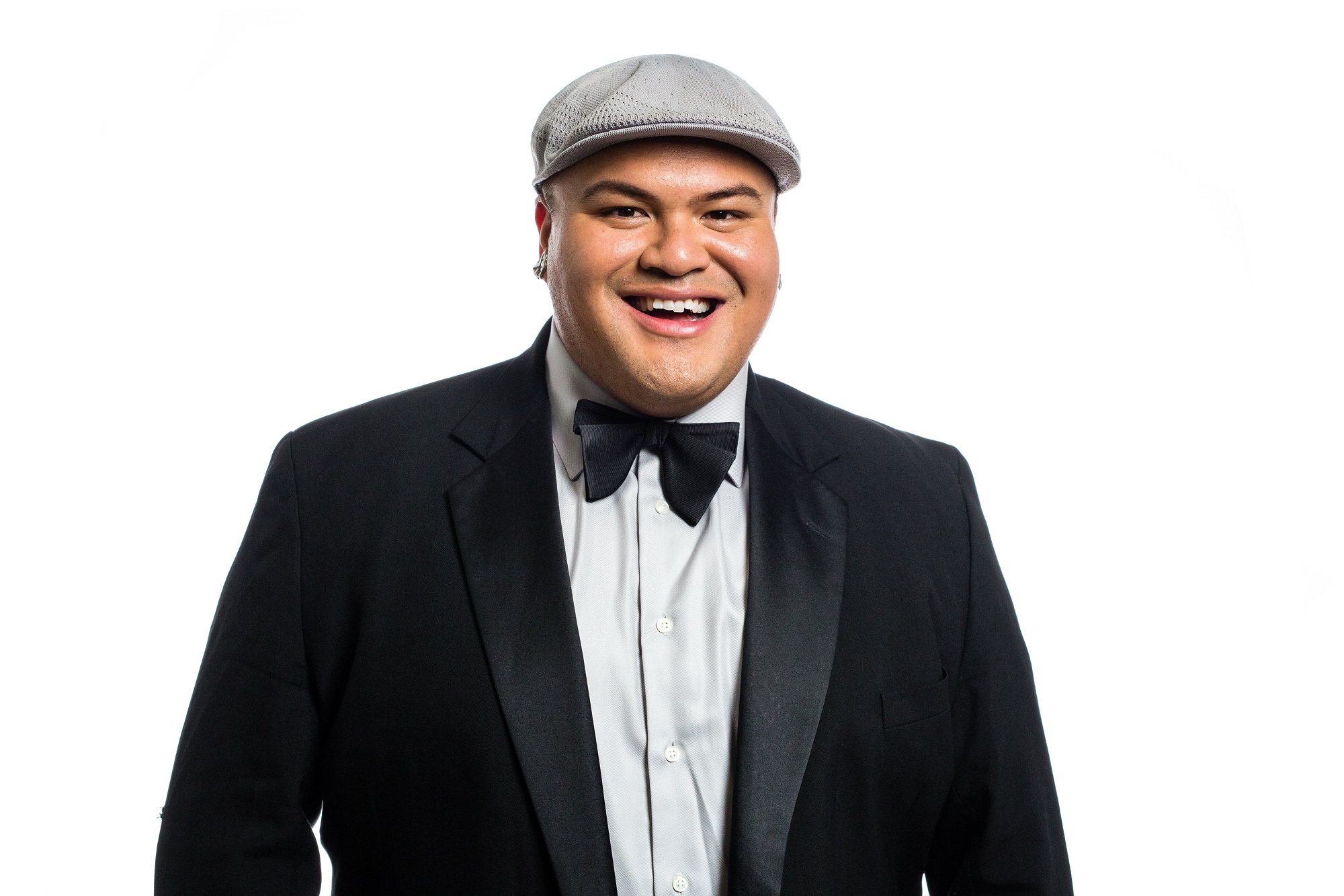 Kalani wearing a suit with bowtie and a cap