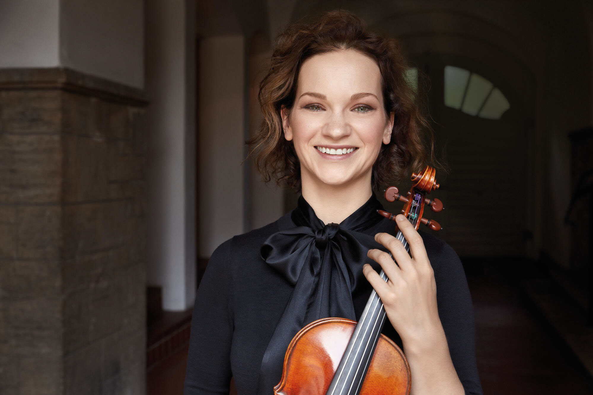 Hilary Hahn smiling with violin